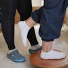 Close-up of a physiotherapy session focusing on balance training with a balance board.